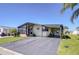 Charming single-story home featuring a covered porch, extended driveway and lush landscaping at 3051 Shady Creek Dr, Wesley Chapel, FL 33543