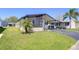 Charming single-story home featuring a covered porch, extended driveway and lush landscaping at 3051 Shady Creek Dr, Wesley Chapel, FL 33543