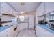 Cozy kitchen featuring white cabinetry, blue countertops and essential appliances at 3051 Shady Creek Dr, Wesley Chapel, FL 33543