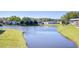 Picturesque water view showcasing a row of well-maintained homes in a tranquil community at 3051 Shady Creek Dr, Wesley Chapel, FL 33543