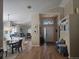 Inviting foyer featuring wood flooring, elegant lighting, and seamless transition into the kitchen and dining area at 31150 Harthorn Ct, Wesley Chapel, FL 33543