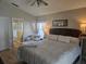 Serene main bedroom featuring wood flooring, a comfortable bed, and an en-suite bathroom at 31150 Harthorn Ct, Wesley Chapel, FL 33543