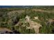 A high-angle view of a lot, revealing lush vegetation and a possible development site surrounded by mature trees at 317 Old East Lake Rd, Tarpon Springs, FL 34688
