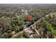 Expansive aerial view of wooded property featuring a home and outbuildings among lush trees at 317 Old East Lake Rd, Tarpon Springs, FL 34688