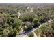 Scenic aerial view showcasing wooded acreage, revealing a peaceful home site nestled in nature at 317 Old East Lake Rd, Tarpon Springs, FL 34688