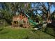 Backyard featuring a playset and seating area at 317 Old East Lake Rd, Tarpon Springs, FL 34688