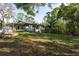 Backyard featuring a lush green lawn at 317 Old East Lake Rd, Tarpon Springs, FL 34688