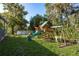 Backyard featuring a playset and above ground pool at 317 Old East Lake Rd, Tarpon Springs, FL 34688