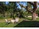 Backyard featuring a fire pit with chairs at 317 Old East Lake Rd, Tarpon Springs, FL 34688