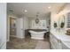 Elegant bathroom with hardwood floors, a freestanding tub, and ample natural light at 317 Old East Lake Rd, Tarpon Springs, FL 34688