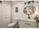 Charming bathroom features modern vanity, stylish lighting, shiplap accent wall, and black and white tile floor at 317 Old East Lake Rd, Tarpon Springs, FL 34688
