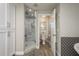 Bright bathroom with a glass shower door and wooden-look tile at 317 Old East Lake Rd, Tarpon Springs, FL 34688