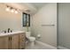 Well-lit bathroom showcasing a modern vanity, neutral tile, and fixtures, offering a refreshing and functional space at 317 Old East Lake Rd, Tarpon Springs, FL 34688