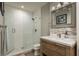 Bathroom with white subway tiles and a wood vanity at 317 Old East Lake Rd, Tarpon Springs, FL 34688