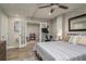 Bedroom with a bed, ceiling fan, French doors, and exercise equipment at 317 Old East Lake Rd, Tarpon Springs, FL 34688