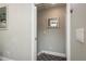 Clean entryway featuring a built-in coat rack, utility closet, and modern carpeting at 317 Old East Lake Rd, Tarpon Springs, FL 34688