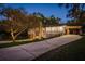 Charming two-story home with stone accents, lush landscaping, and spacious driveway at 317 Old East Lake Rd, Tarpon Springs, FL 34688