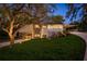 Inviting two-story home boasting stone accents, modern siding, and lush landscaping at 317 Old East Lake Rd, Tarpon Springs, FL 34688