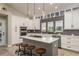Bright kitchen with subway tile backsplash, kitchen island with bar seating and pendant lighting at 317 Old East Lake Rd, Tarpon Springs, FL 34688
