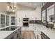 Beautiful kitchen featuring modern appliances, ample counter space, and stylish pendant lighting at 317 Old East Lake Rd, Tarpon Springs, FL 34688