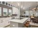 Modern kitchen featuring island with seating, stainless appliances, and stylish lighting fixtures at 317 Old East Lake Rd, Tarpon Springs, FL 34688