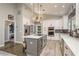 Modern kitchen with stainless steel appliances, island, and ample storage space at 317 Old East Lake Rd, Tarpon Springs, FL 34688