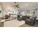 Spacious living room with modern ceiling fan, hardwood floors, and a large sectional sofa at 317 Old East Lake Rd, Tarpon Springs, FL 34688