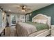 Comfortable main bedroom with hardwood floors, an accent wall, and access to the exterior at 317 Old East Lake Rd, Tarpon Springs, FL 34688