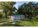 Above ground pool surrounded by lush green grass and trees at 317 Old East Lake Rd, Tarpon Springs, FL 34688
