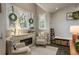 Cozy sitting room featuring comfortable chairs, decorative pillows, and a charming electric fireplace at 317 Old East Lake Rd, Tarpon Springs, FL 34688