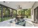 Enclosed sunroom includes a dining area with backyard views and a peaceful place to relax and unwind at 317 Old East Lake Rd, Tarpon Springs, FL 34688