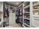 Organized walk-in closet with built-in shelving, drawers, and ample storage space at 317 Old East Lake Rd, Tarpon Springs, FL 34688