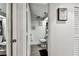 This bathroom is painted white with wooden floors and black rugs plus tasteful artwork at 36750 Us 19 N # 17106, Palm Harbor, FL 34684