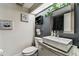 Modern bathroom features a vessel sink, granite countertop, and sleek black shelving with plants at 36750 Us 19 N # 17106, Palm Harbor, FL 34684