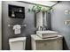 Modern bathroom features a vessel sink, granite countertop, and sleek black shelving with plants at 36750 Us 19 N # 17106, Palm Harbor, FL 34684
