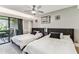 Bright bedroom with two beds, sliding door, and outdoor access at 36750 Us 19 N # 17106, Palm Harbor, FL 34684