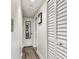 Hallway with wooden floors, closet, and bathroom access in a well-lit, modern space at 36750 Us 19 N # 17106, Palm Harbor, FL 34684