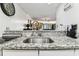 Kitchen has sleek sink and granite countertops that look out to the open living room at 36750 Us 19 N # 17106, Palm Harbor, FL 34684