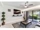 Living room with TV, modern decor, and sliding glass doors to a patio at 36750 Us 19 N # 17106, Palm Harbor, FL 34684