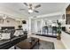 Living room with a view into the kitchenette, a large TV, and sliding doors at 36750 Us 19 N # 17106, Palm Harbor, FL 34684