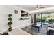 Bright living room with a large TV, modern decor, and sliding glass doors leading to a patio at 36750 Us 19 N # 17106, Palm Harbor, FL 34684