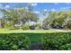 Exterior shot of the parking lot showing the parking area and trees in front of the building at 36750 Us 19 N # 17106, Palm Harbor, FL 34684