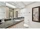 Elegant bathroom vanity with granite countertop, modern fixtures, and decorative lighting at 36750 Us 19 N # 22207, Palm Harbor, FL 34684