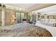 Well-lit bedroom with open windows next to seating and mirrored wall, providing a stylish layout at 36750 Us 19 N # 22207, Palm Harbor, FL 34684