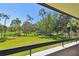 Expansive golf course view from balcony, showcasing lush greenery and mature trees surrounding the manicured fairways at 36750 Us 19 N # 22207, Palm Harbor, FL 34684