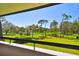 Stunning balcony view overlooking the meticulously maintained golf course with mature trees and lush green grass at 36750 Us 19 N # 22207, Palm Harbor, FL 34684
