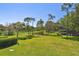 Breathtaking view of the lush golf course from the balcony, with mature trees dotting the landscape at 36750 Us 19 N # 22207, Palm Harbor, FL 34684
