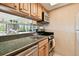 Bright kitchen with stainless appliances, green countertops, and a mirrored backsplash for an open feel at 36750 Us 19 N # 22207, Palm Harbor, FL 34684