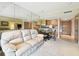 Inviting living room with couch, table and chairs, mirrors, adjacent to kitchen and bedroom area at 36750 Us 19 N # 22207, Palm Harbor, FL 34684