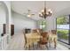 Bright dining area featuring a chandelier and natural light from the adjacent backyard views at 4015 Mountain Springs Ln, Tampa, FL 33624